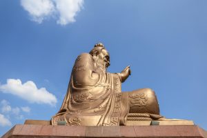 Laozi statue at Yuanxuan Taoist Temple with a clear blue sky backdrop.
